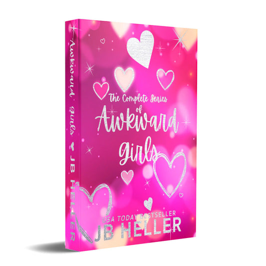 A hardback book with a pink cover featuring hearts and the title 'Awkward Girls' by JB Heller.